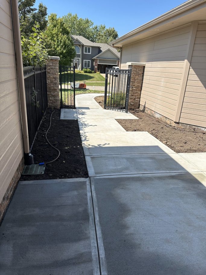 A completed concrete project showcasing the finished front entry that leads out to the driveway