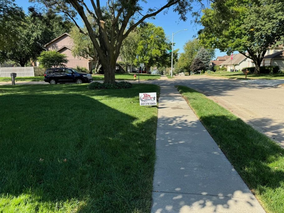 A complete repoured concrete neighborhood sidewalk.