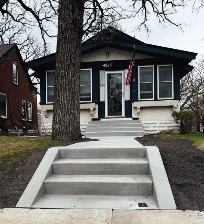 New stairs and pathway leading to the home entry. The stairs are freshly installed with a smooth, even concrete surface