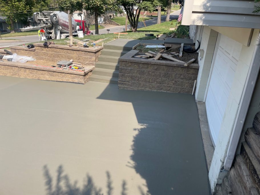 A completed 3-part transformation that included newly poured concrete driveway, functional stairs, and a welcoming front stoop.