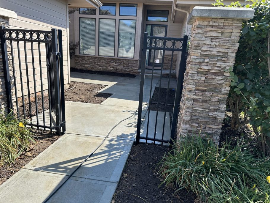 A completed concrete project showcasing the finished front entry that leads to a small courtyard and front door